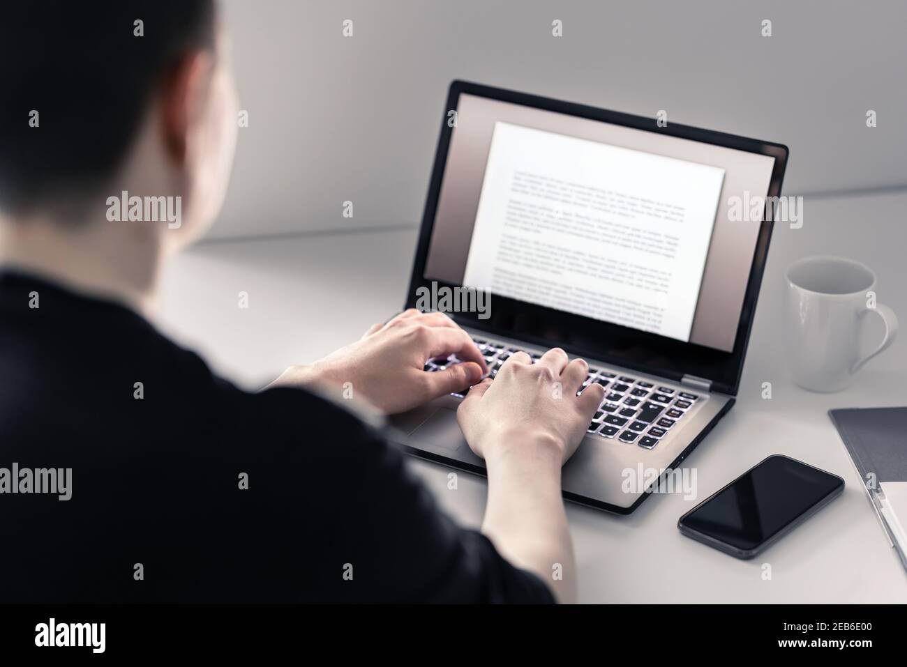 Man writing with laptop. Job applicant making his resume, cv or application. Freelance writer, journalist or teacher working in home office. Stock Photo