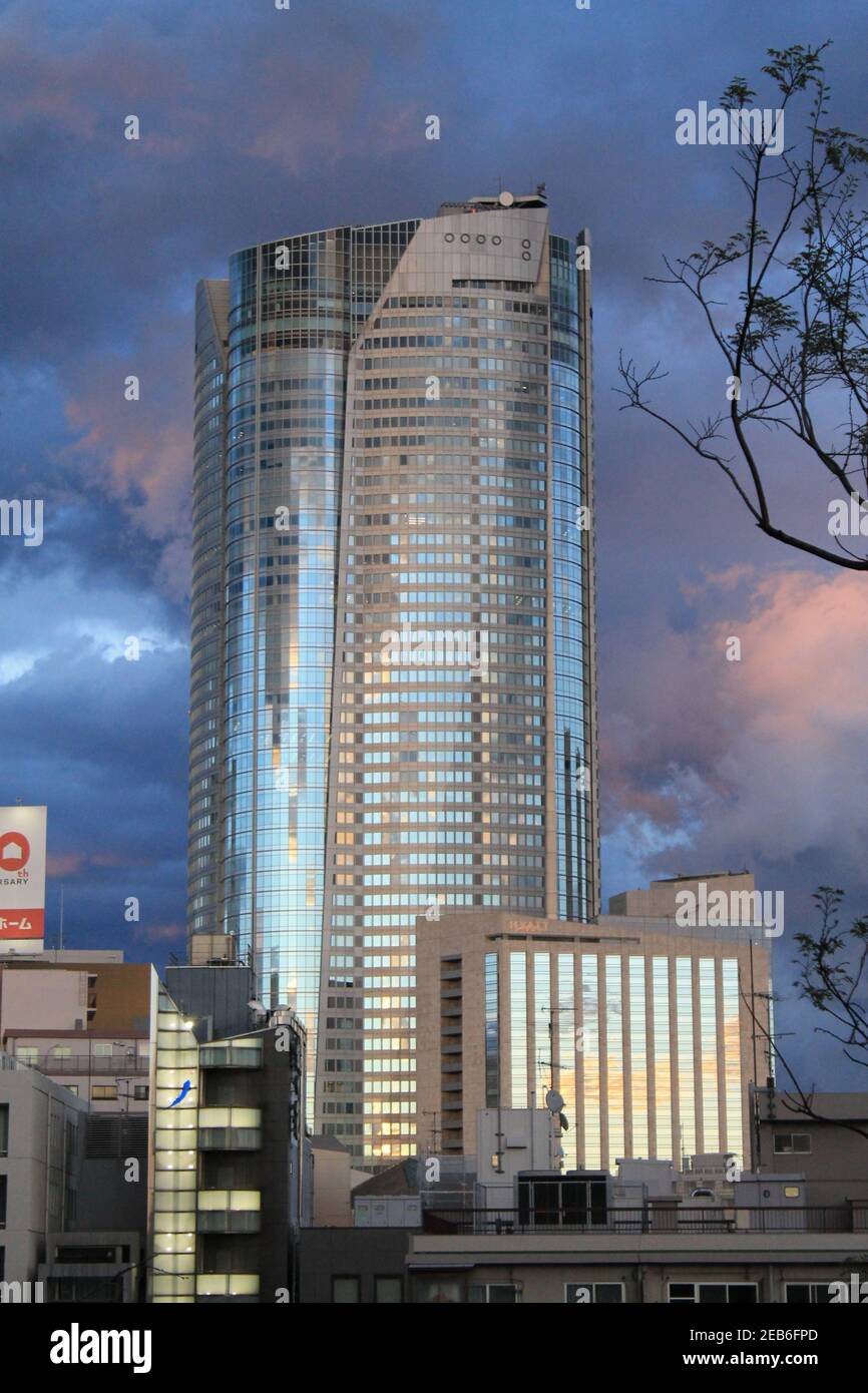 TOKYO, JAPAN - Apr 07, 2013: The Mori Tower in Roppongi with sunny reflections at dusk Stock Photo