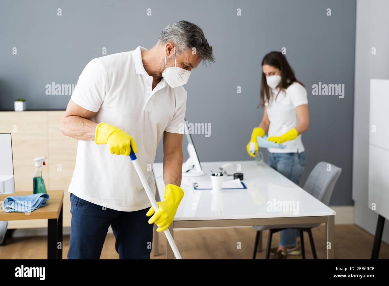 Cleaning Service Janitor Cleaner With Mop In Face Mask Stock Photo