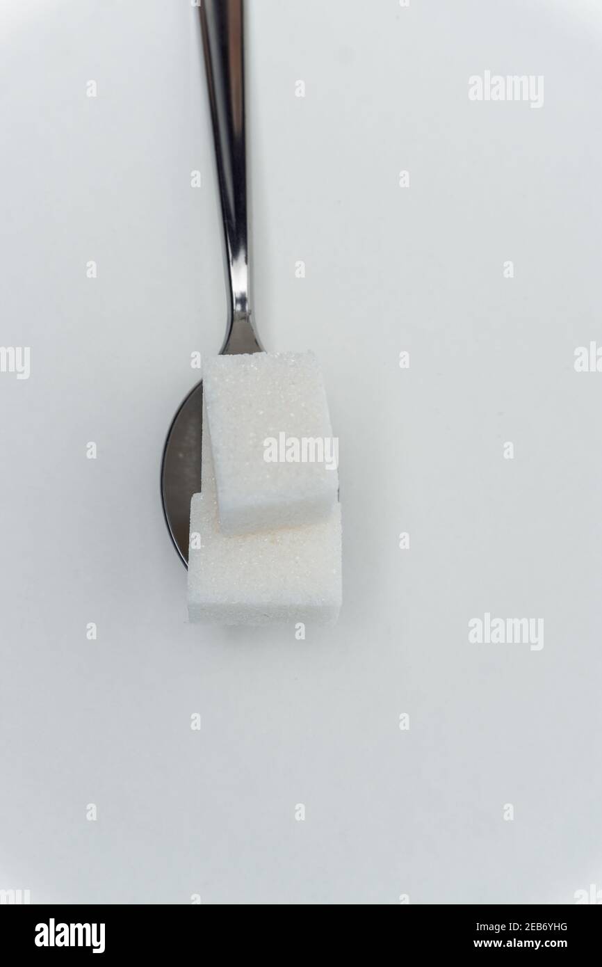 sugar cubes in a teaspoon sweets calorie ingredient Glucose Stock Photo