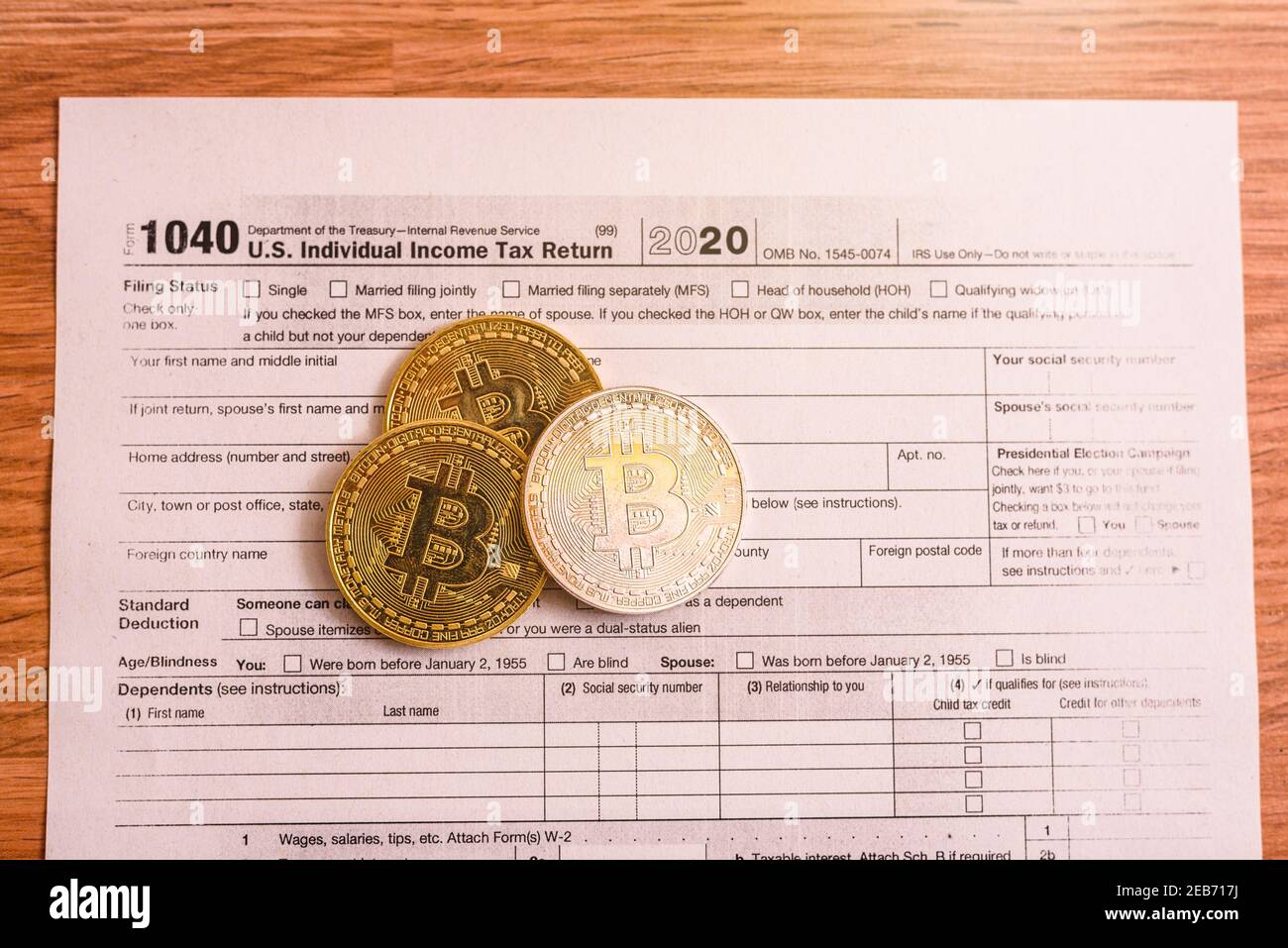 Form 1040 for 2020 with bitcoin coins for reporting of gains from cyber  currency trading or investment Stock Photo - Alamy