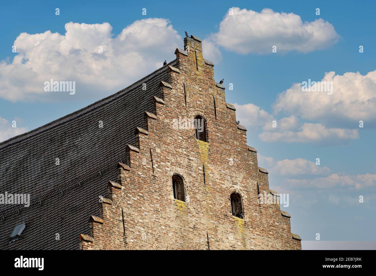Low angle shot of an old brick mansion under the cloudy sky Stock Photo ...