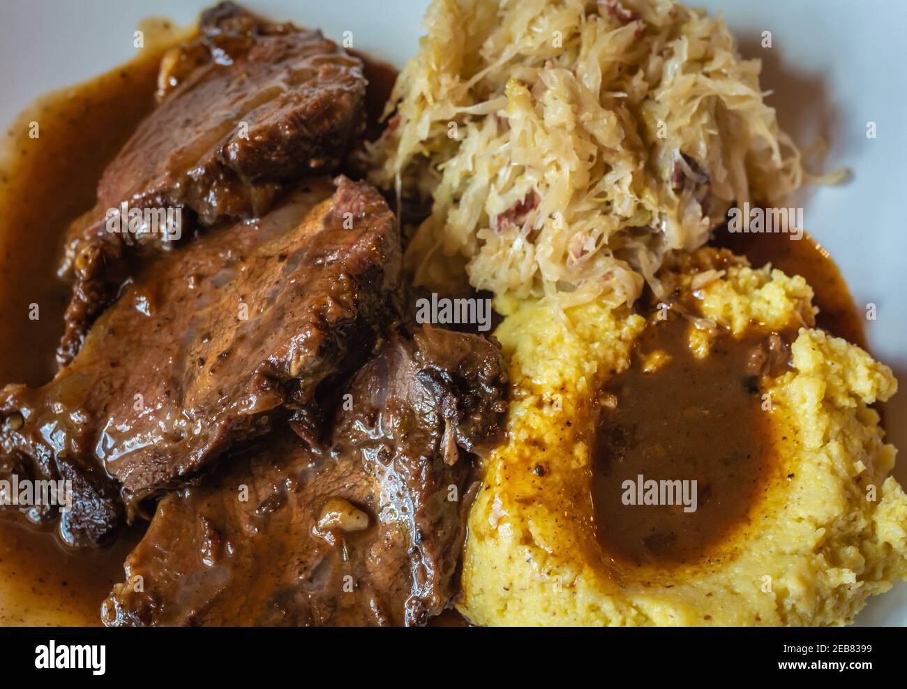 pork ribs with polenta and sauerkraut. Typical Trentino dish - italian cuisine Stock Photo
