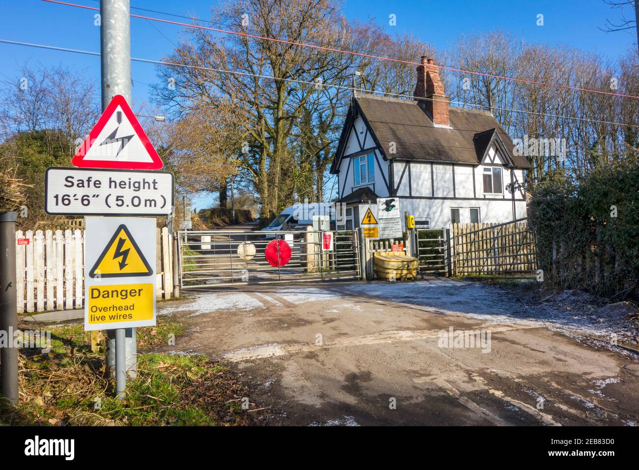 Rural countryside railway level crossing with manually operated gate to open to allow you to cross  in  Oakhanger Barhomley Cheshire Stock Photo