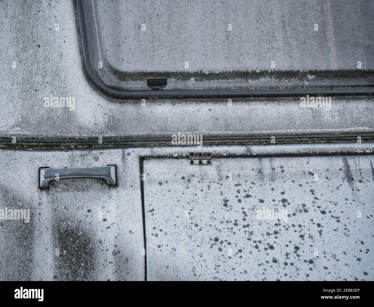 Black mould on the front of an abandoned caravan. Extensive mould
