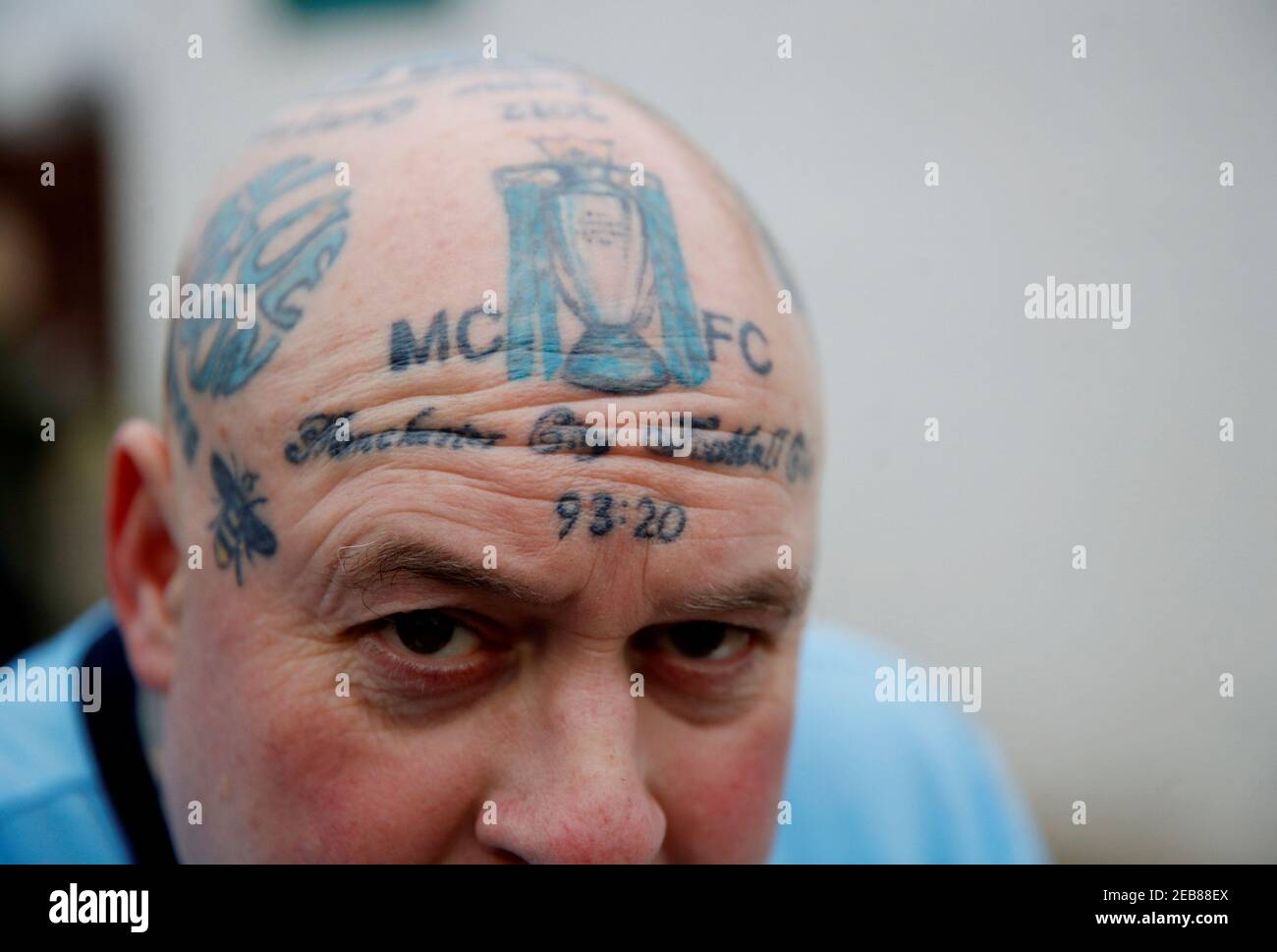 Soccer Football - Premier League - Manchester City v Arsenal - Etihad  Stadium, Manchester, Britain - February 3, 2019 A Manchester City fan poses  with a Manchester City tattoo on his head