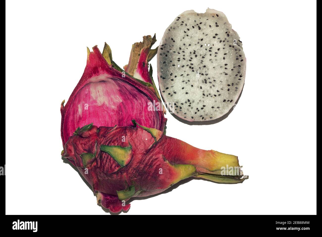 sliced dragon fruit. half without scaly skin; a whole quarter of tropical exotic bright pink fruit with white pulp with small black seeds; isolated on Stock Photo