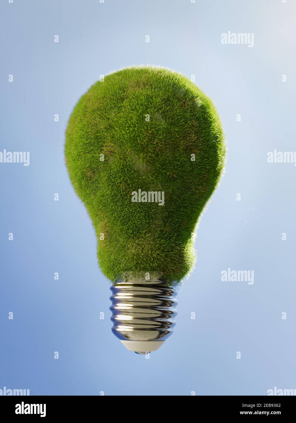 3D rendering of lightbulb with glass part covered with green grass against blue sky Stock Photo