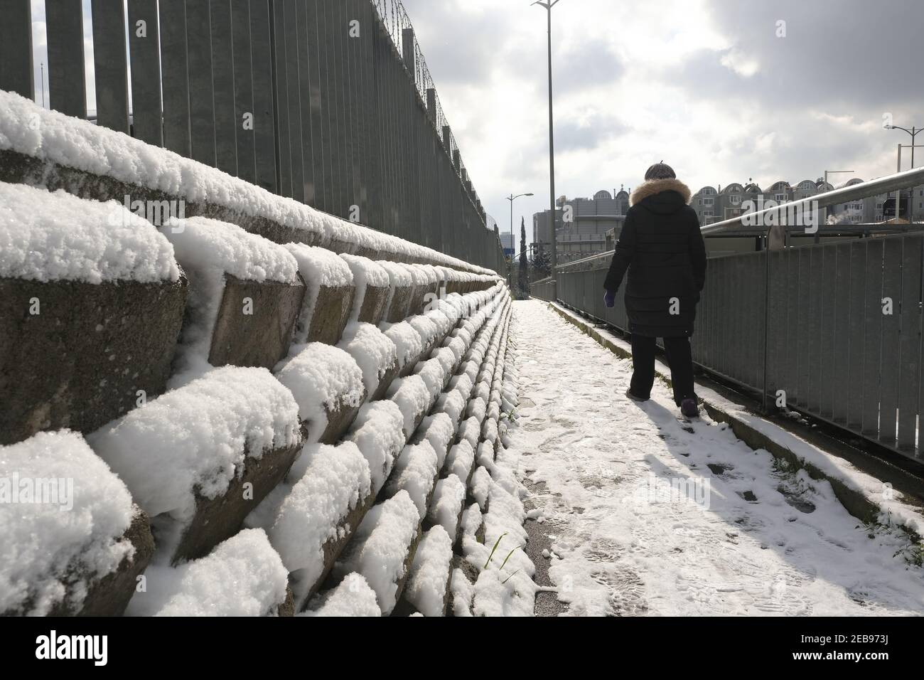 Woman walking on snowy hi-res stock photography and images - Alamy