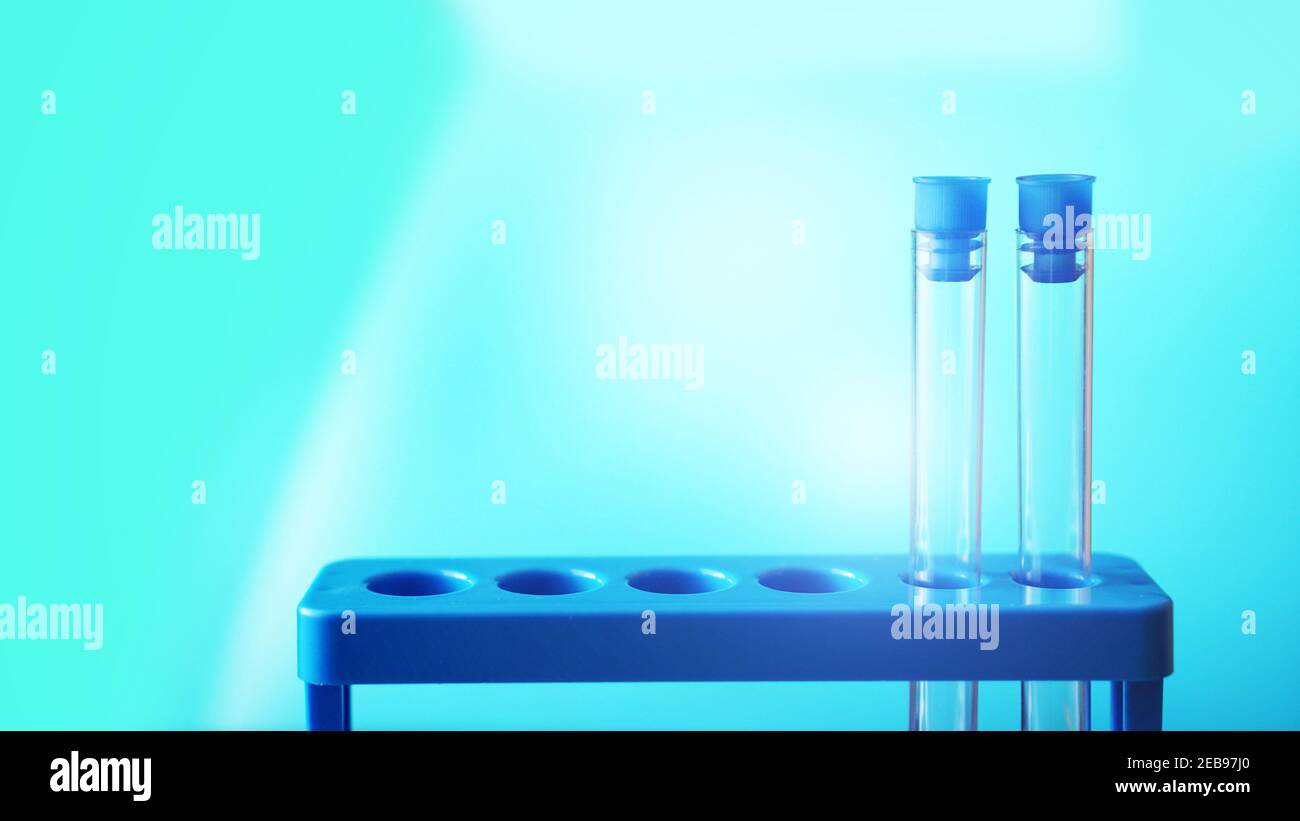 Test-tubes on a blue stand against blurred blue background Stock Photo ...