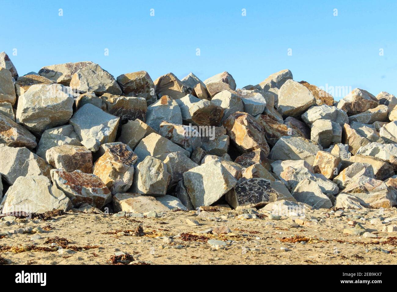 Rip rap aka rock armour aka shot rock on Marazion beach. The sea defences protect the beach from coastal erosion Stock Photo