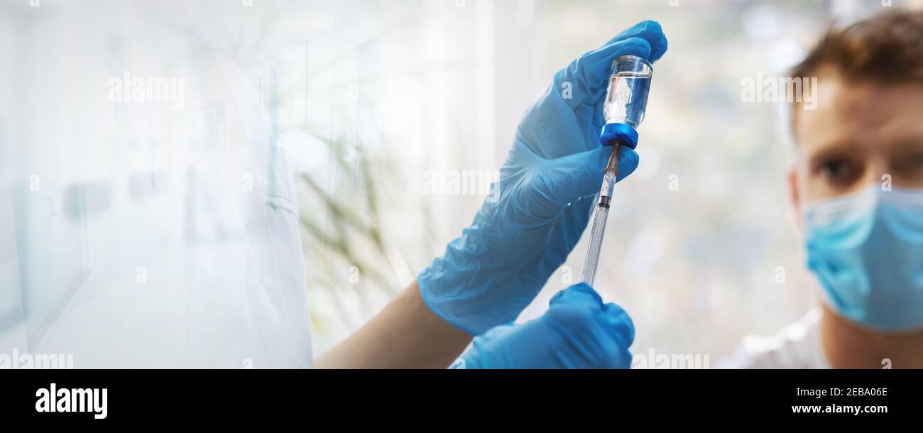 vaccination banner. filling the syringe with vaccine from vial. copy space Stock Photo