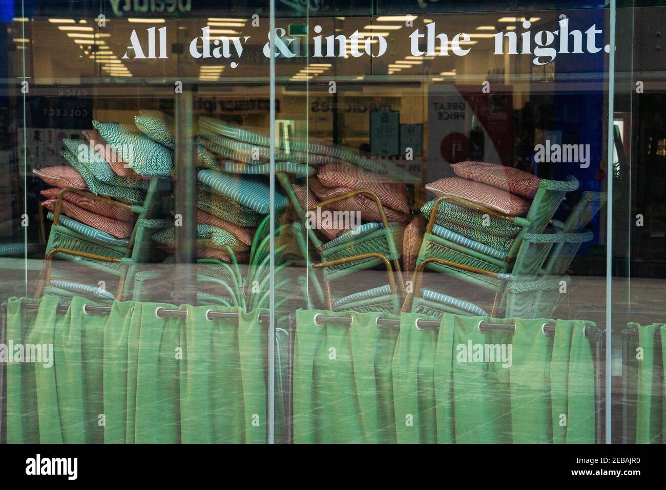 Chairs are stacked in the window of a closed restaurant at a shopping centre in Victoria, central London. The UKÕs economy shrunk at its fastest rate since the 1920s last year, as the pandemic forced thousands of businesses to remain closed for several months. Picture date: Friday February 12, 2021. Stock Photo