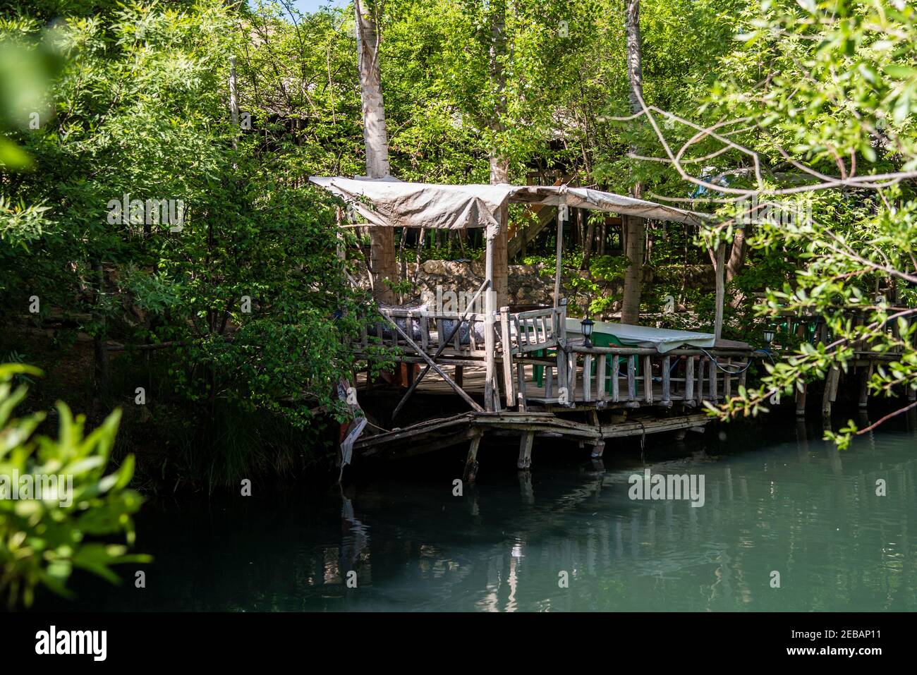 Wooden gazebo built on a stream among the trees Stock Photo - Alamy