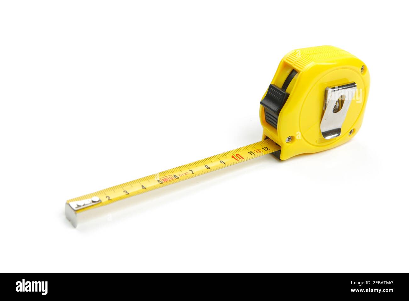 Partially unwound yellow tape measure, cut out and isolated on white background Stock Photo