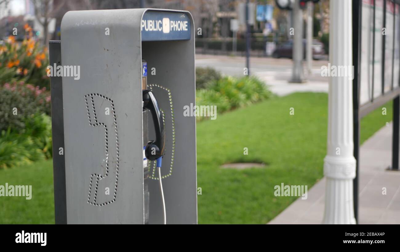 Retro coin-operated payphone station for emergency call on street, California USA. Public analog pay phone booth. Outdated technology for connection a Stock Photo