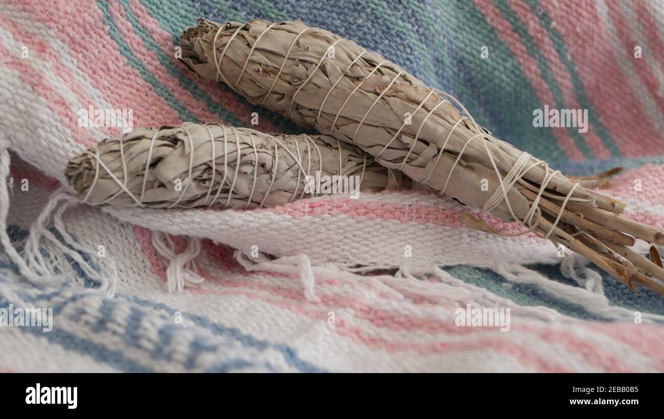 Dried white sage smudge stick, relaxation and aromatherapy. Smudging during psychic occult ceremony, herbal healing, yoga or aura cleaning. Essential Stock Photo