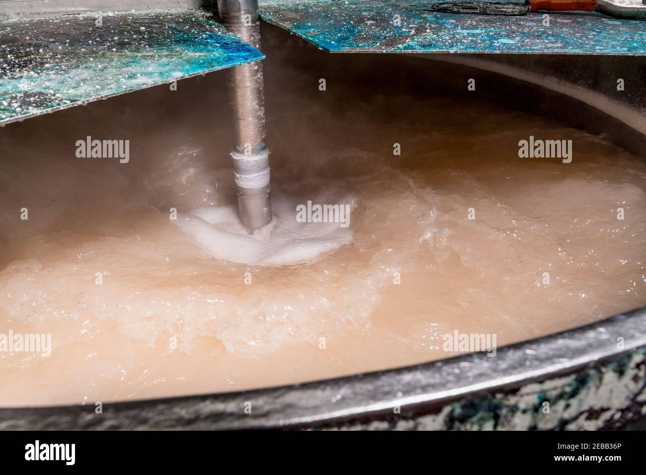 Swirling chemicals in industrial mixer detail Stock Photo