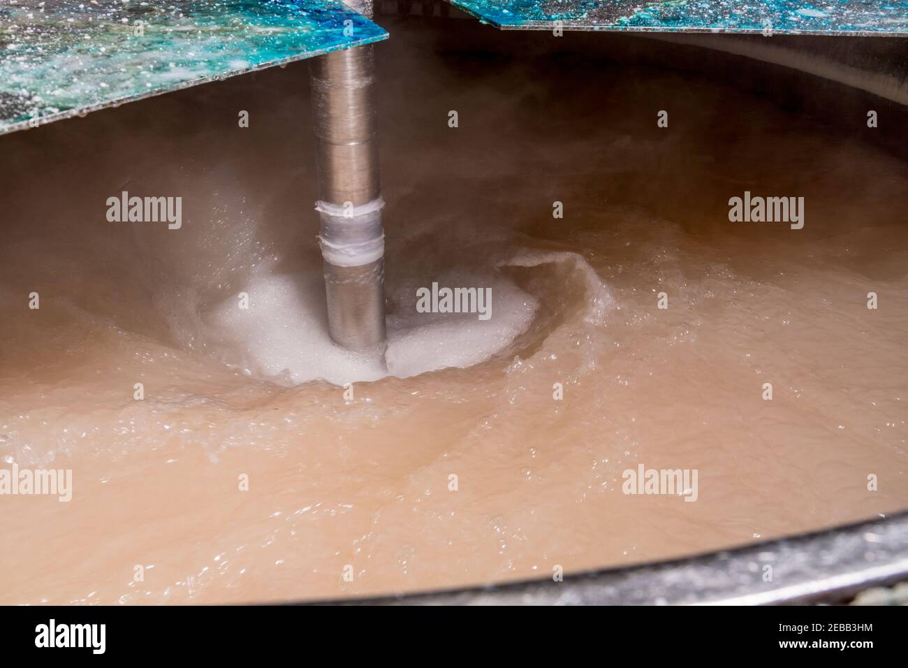 Swirling chemicals in industrial mixer detail Stock Photo