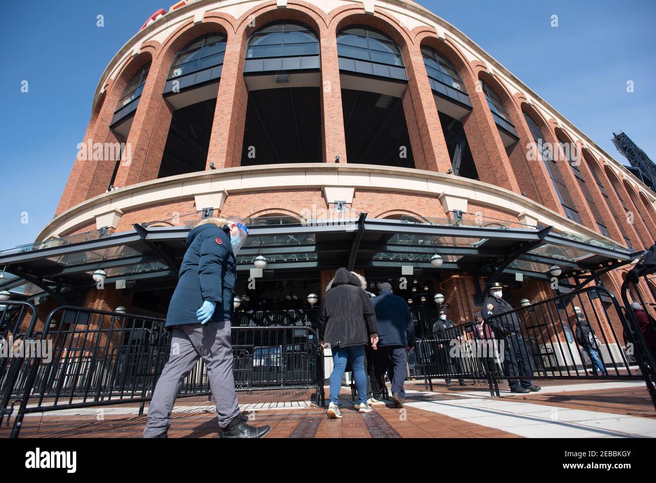 People wait in line to enter a coronavirus (COVID-19) vaccination site at Citi Field on February 10, 2021 in the Queens borough of New York City. The Stock Photo