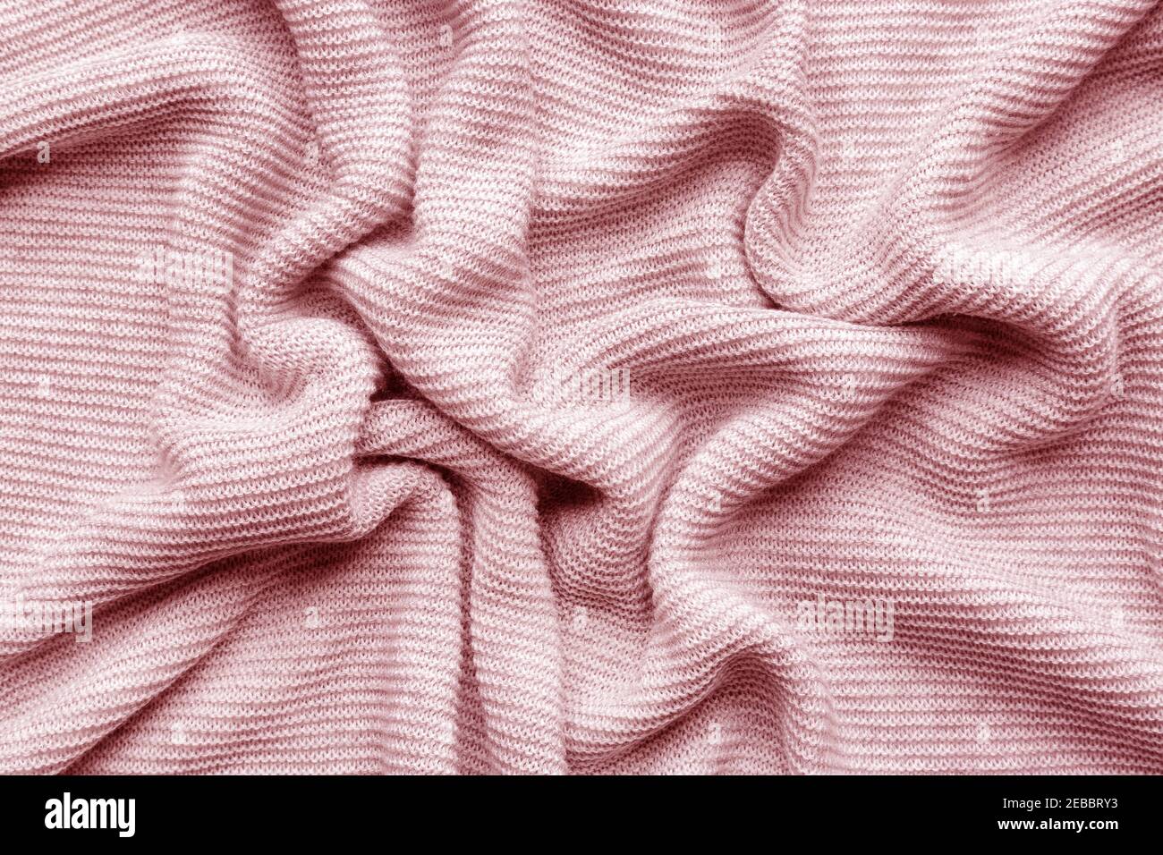 Pink woolen knitted fabric as background Stock Photo