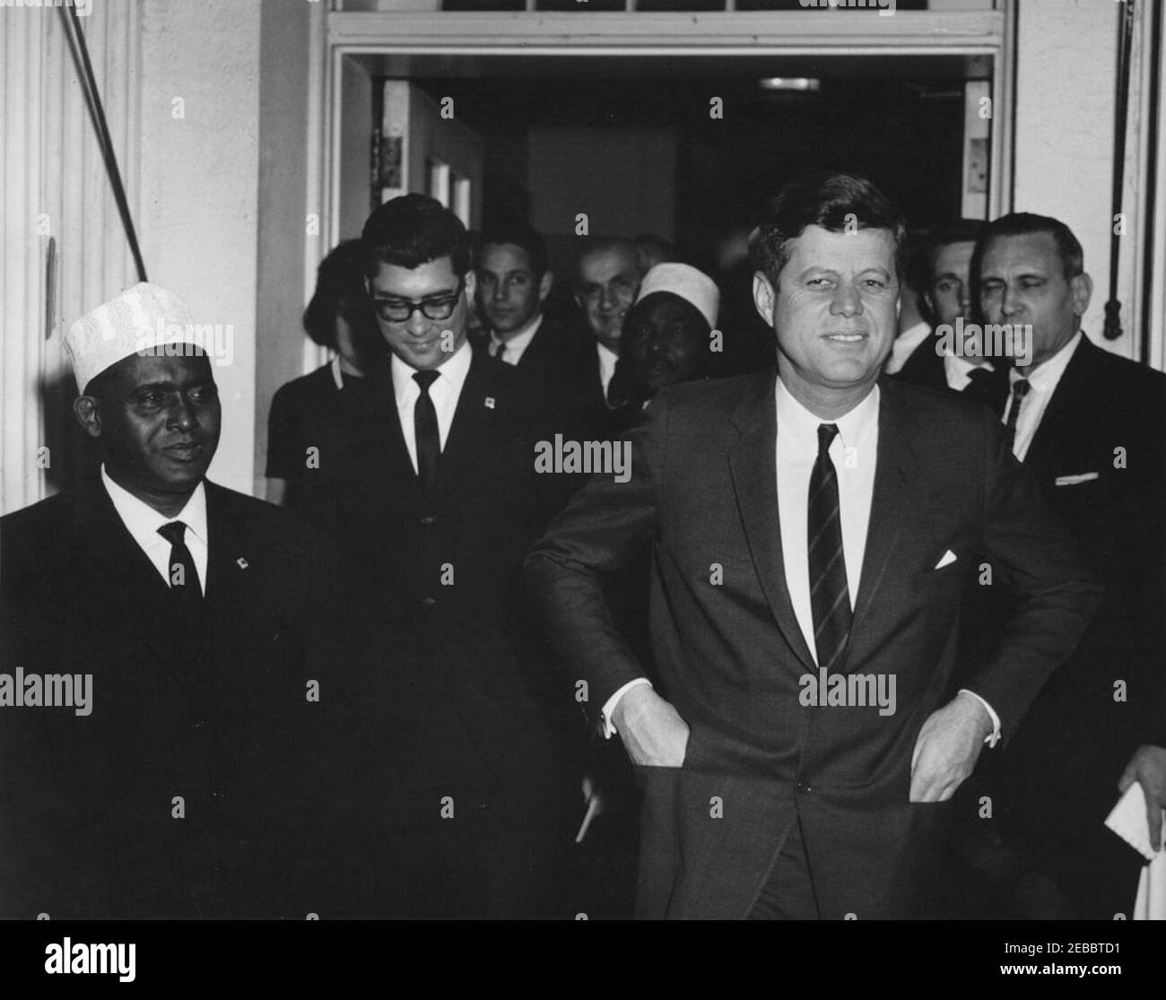 Meeting with Abdirashid Ali Shermarke, Prime Minister of the Somali Republic, 4:00PM. President John F. Kennedy and Prime Minister of the Somali Republic, Dr. Abdirashid Ali Shermarke (left), exit the White House following a meeting. Also pictured: U.S. State Department interpreter, Neil Seidenman; U.S. Deputy Assistant Secretary of State for African Affairs, Henry J. Tasca; White House Secret Service agent, Jerry Blaine. West Wing Entrance, White House, Washington, D.C. Stock Photo