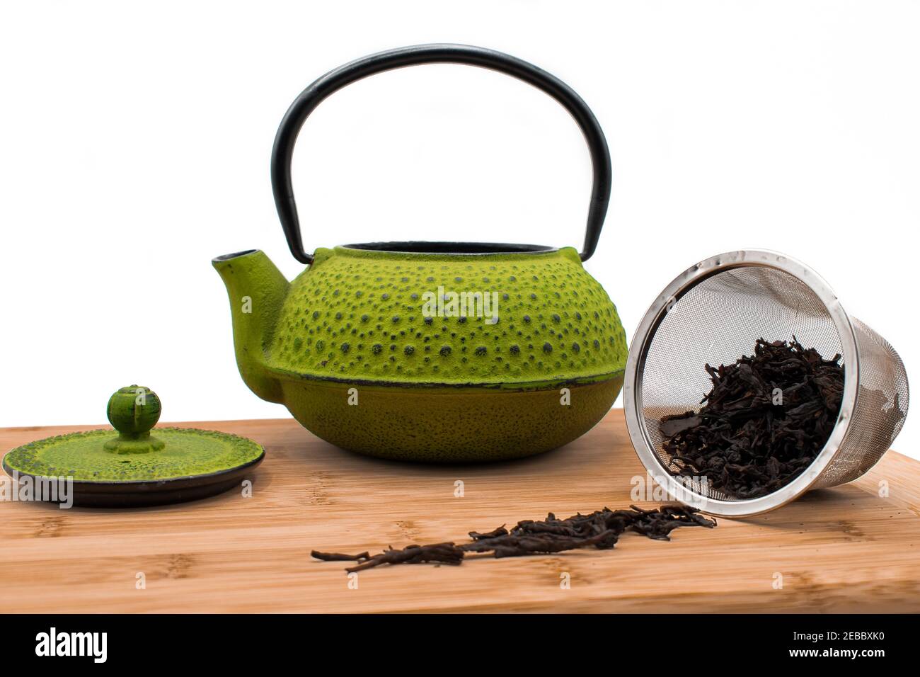 green teapot on wooden board Stock Photo
