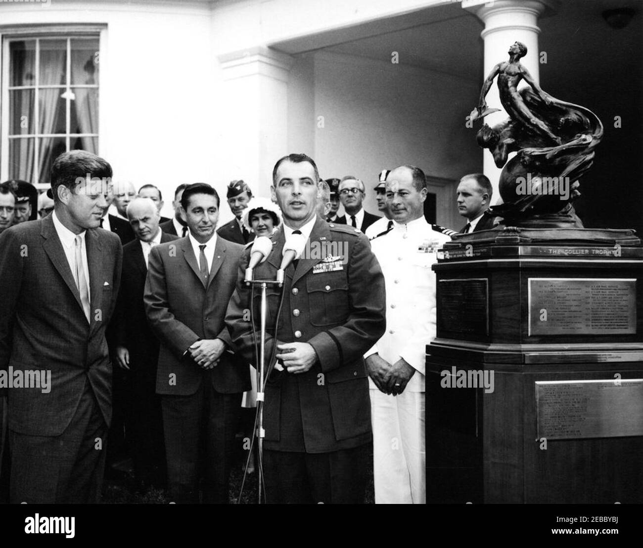 Presentation of the 1961 Collier Trophy, 11:30AM. Major Robert M. White (U.S. Air Force) delivers remarks upon receiving the 1961 Robert J. Collier Trophy; President John F. Kennedy presented the trophy to four X-15 pilots on behalf of the National Aeronautic Association (NAA). Also pictured: trophy recipients, A. Scott Crossfield (North American Aviation) and Commander Forrest S. Petersen (U.S. Navy); General Omar Bradley; Secretary of the Air Force, Eugene M. Zuckert; White House Secret Service agent, Frank Yeager. West Wing Lawn, White House, Washington, D.C. Stock Photo