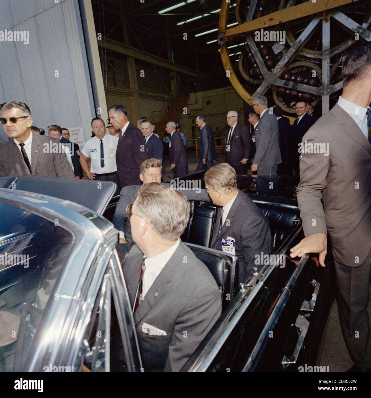 Inspection tour of NASA installations: Huntsville Alabama, Redstone Army Airfield and George C. Marshall Space Flight Center, 9:35AM. President John F. Kennedy and Director of the George C. Marshall Space Flight Center (MSFC), Dr. Wernher von Braun (back to camera), sit in the back seat of the presidential limousine, following a tour MSFC facilities at Redstone Arsenal, Huntsville, Alabama. Also pictured: Representative Albert Thomas (Texas); Representative George P. Miller (California); Associate Administrator of the National Aeronautics and Space Administration (NASA), Dr. Robert C. Seamans, Stock Photo