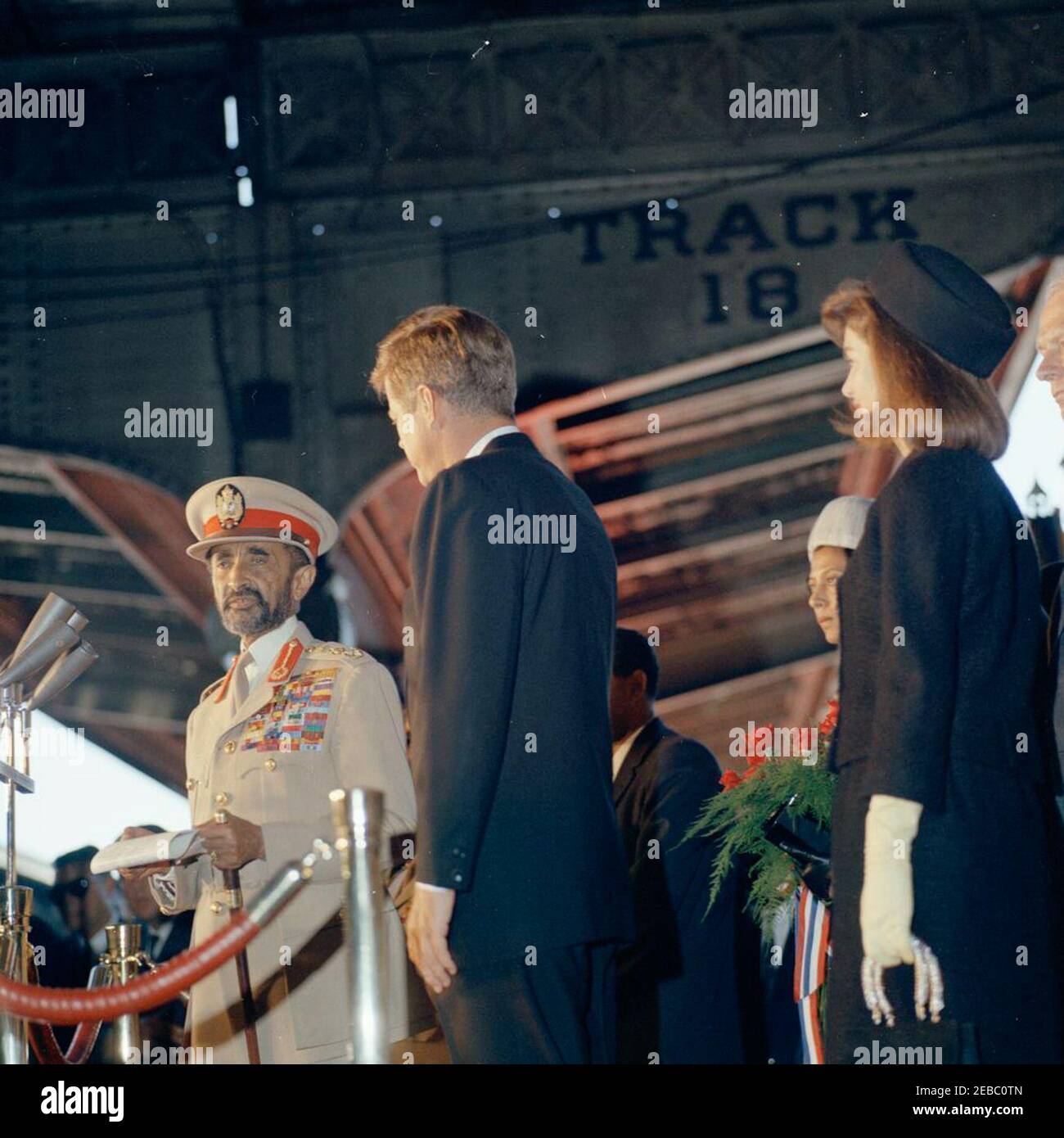 Arrival ceremony for Haile Selassie I, Emperor of Ethiopia, 12:00PM. Emperor of Ethiopia, Haile Selassie I, delivers remarks during an arrival ceremony in his honor; President John F. Kennedy observes. First Lady Jacqueline Kennedy and Princess Hirut u201cRuthu201d Desta, granddaughter of Emperor Selassie, stand at right; U.S. Under Secretary of State, George Ball, stands on far right edge of frame. Union Station, Washington, D.C. Stock Photo