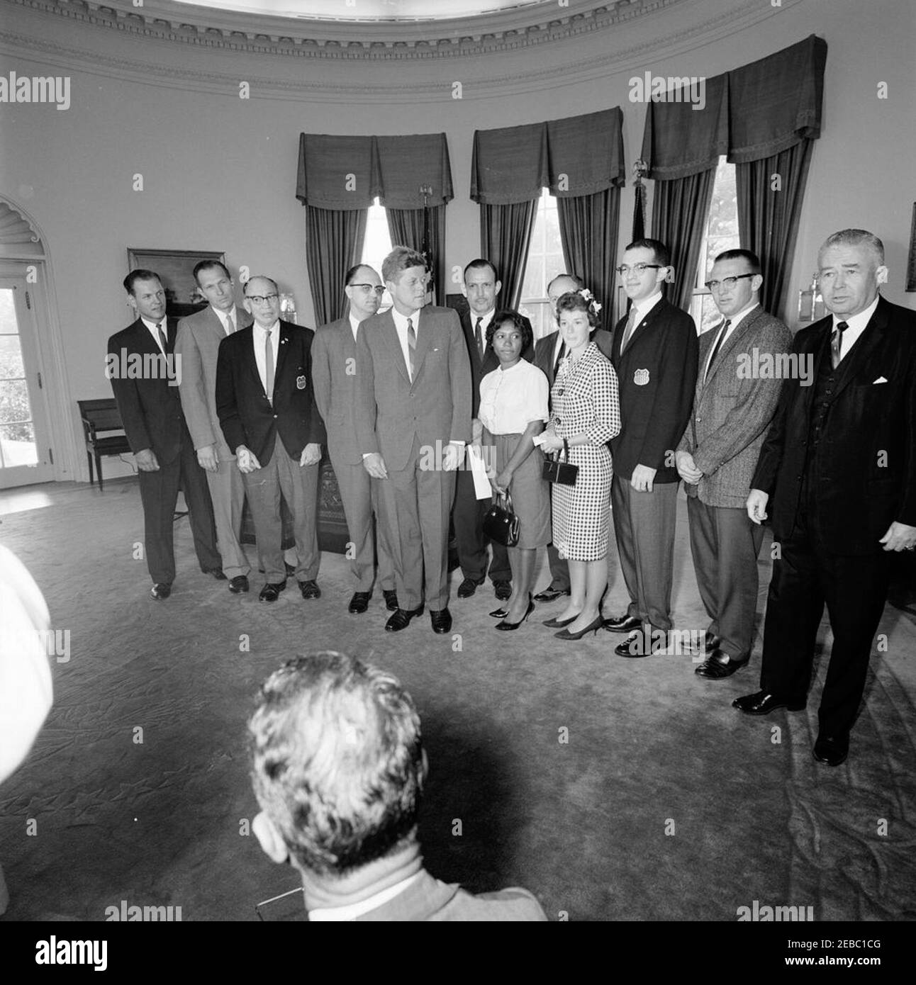 Visit of representatives of the 10th International Games for the Deaf, 10:05AM. President John F. Kennedy visits with representatives of the 10th International Games for the Deaf, sponsored by the American Athletic Association of the Deaf (AAAD). The Games were to be held in Washington, D.C., in 1965. Left to right: Director, Thomas O. Berg; Liaison Officer, Richard M. Phillips; Chairman Emeritus, S. Robey Burns; Chairman, Jerald M. Jordan; President Kennedy; Assistant Chairman, Leon Auerbach; athlete, Mary Lynch; Local Chairman and AAAD President, Alexander Fleischman (partially obscured); at Stock Photo