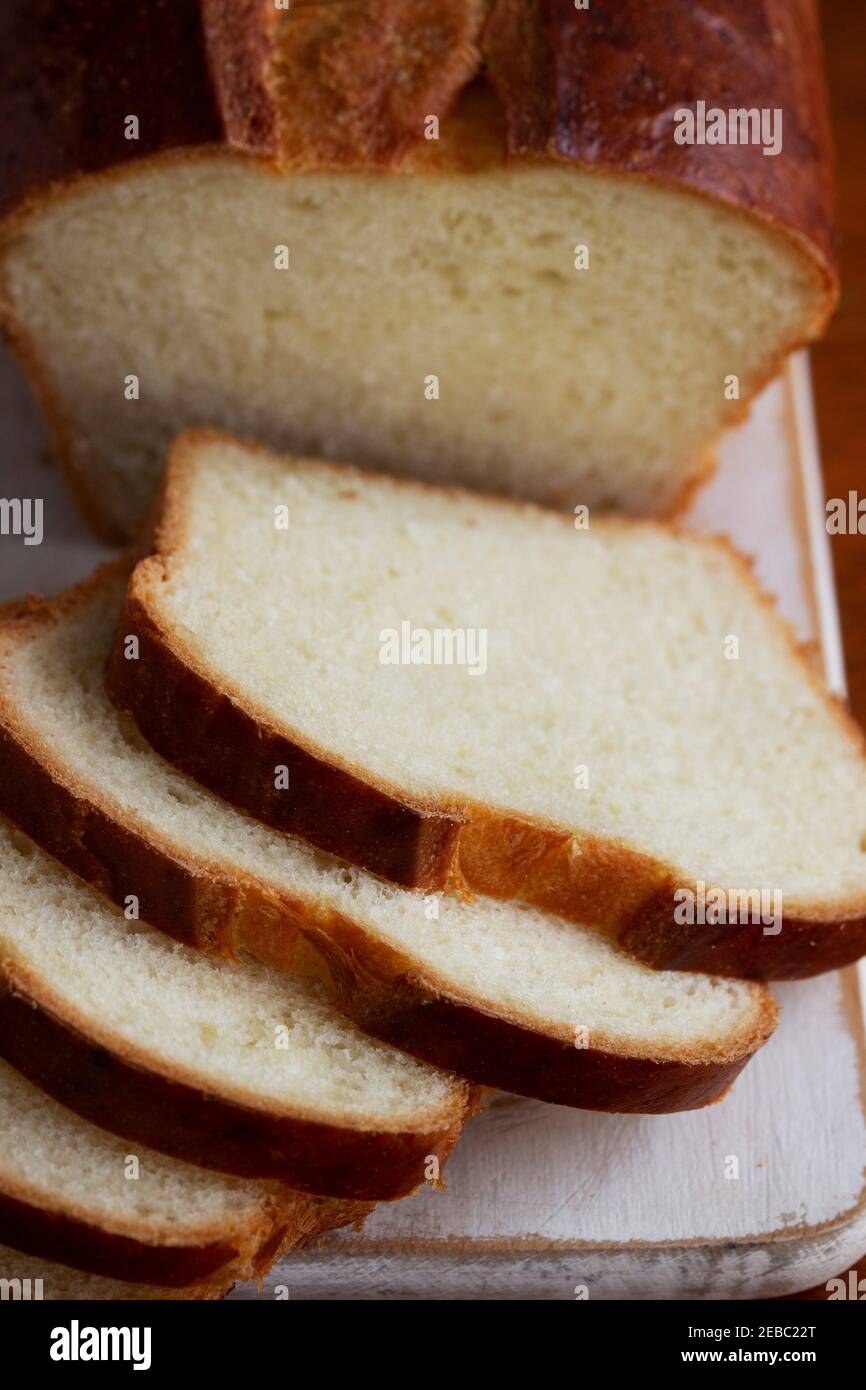 Sweet bread and slices of bread on a wooden table. Stock Photo