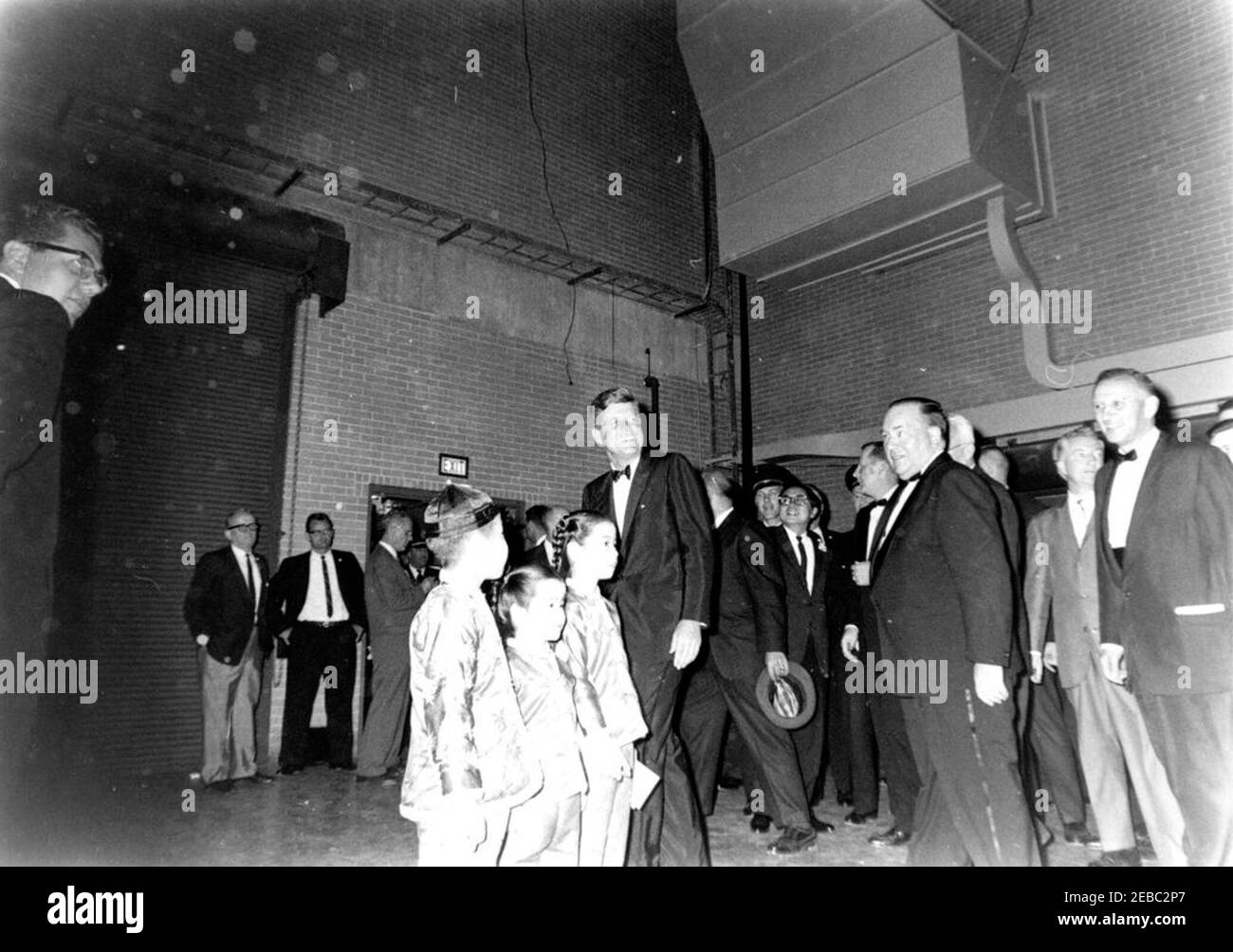 Congressional campaign trip: Chicago, Illinois, arrival, motorcade, address to Cook County Democratic Dinner, address at Aerie Crown Theater. President John F. Kennedy attends a Cook County Democratic dinner at McCormick Place in Chicago, Illinois, during a congressional campaign trip. Mayor of Chicago, Richard J. Daley, and Representative Sidney R. Yates (Illinois) stand at right; three young children stand at center left. Stock Photo