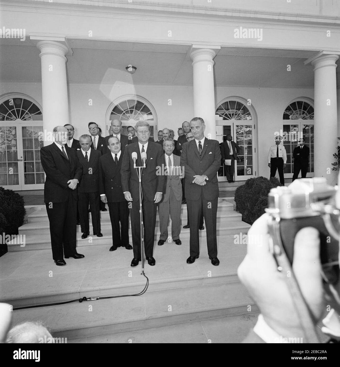 Ceremony marking Vice President Lyndon B. Johnsonu0027s (LBJ) departure on a good-will trip, 3:30PM. President John F. Kennedy delivers remarks during a ceremony marking Vice President Lyndon B. Johnsonu2019s departure for a good-will trip to Lebanon, Iran, Turkey, Greece, Cyprus, and Italy; Vice President Johnson stands at right. Also pictured: Secretary of State, Dean Rusk; Ambassador of Lebanon, Ibrahim Hussein el-Ahdab (al-Ahdab); Ambassador of Italy, Sergio Fenoaltea; Ambassador of Nicaragua and Dean of the Diplomatic Corps, Dr. Guillermo Sevilla-Sacasa; Ambassador of Cyprus, Zenon Ross Stock Photo