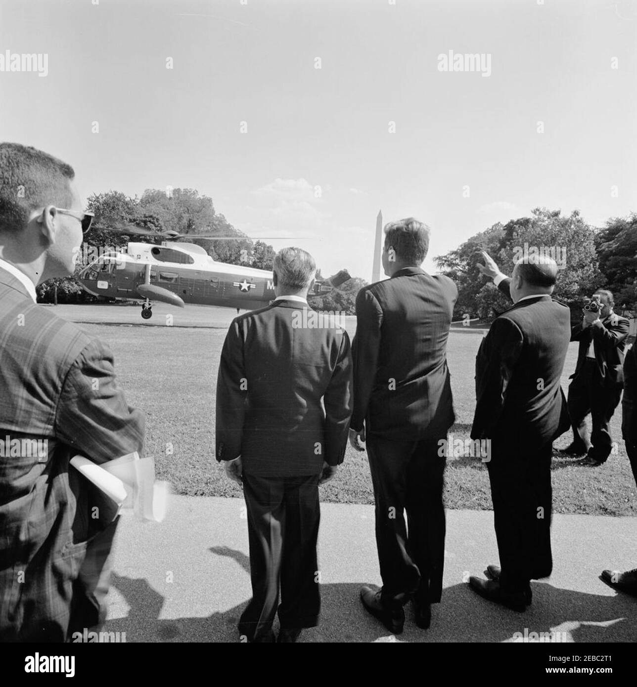 Ceremony marking Vice President Lyndon B. Johnsonu0027s (LBJ) departure on a good-will trip, 3:30PM. President John F. Kennedy and others bid farewell to Vice President Lyndon B. Johnson as his helicopter departs the South Lawn for a good-will trip to Lebanon, Iran, Turkey, Greece, Cyprus, and Italy. Ambassador of Italy, Sergio Fenoaltea, and Ambassador of Nicaragua and Dean of the Diplomatic Corps, Dr. Guillermo Sevilla-Sacasa, stand on either side of President Kennedy. White House, Washington, D.C. Stock Photo