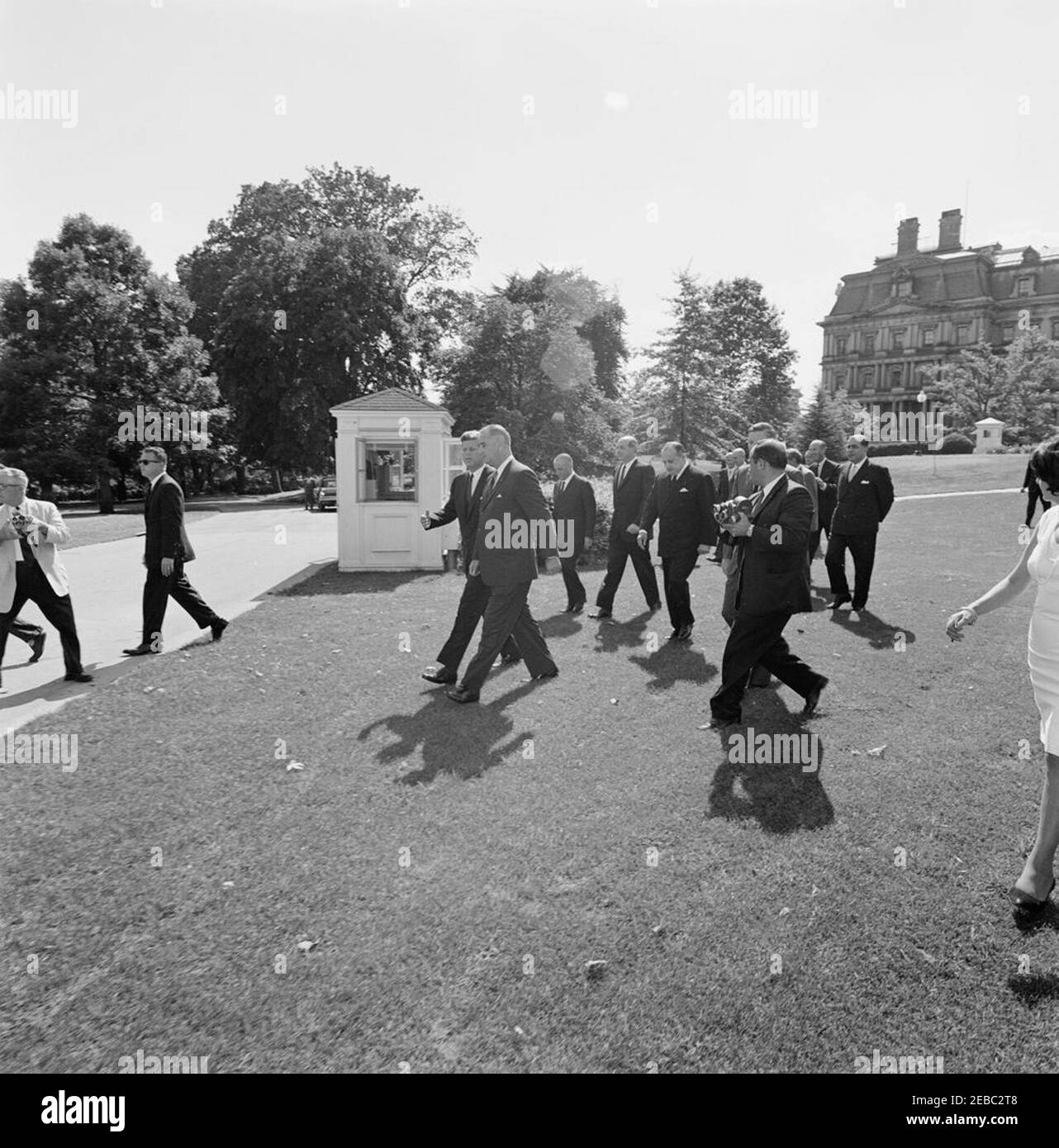 Ceremony marking Vice President Lyndon B. Johnsonu0027s (LBJ) departure on a good-will trip, 3:30PM. President John F. Kennedy walks with Vice President Lyndon B. Johnson to a helicopter on the South Lawn, prior to Vice President Johnsonu2019s departure for a good-will trip to Lebanon, Iran, Turkey, Greece, Cyprus, and Italy. Also pictured: Ambassador of Italy, Sergio Fenoaltea; Secretary of State, Dean Rusk; Ambassador of Nicaragua and Dean of the Diplomatic Corps, Dr. Guillermo Sevilla-Sacasa; Chief of Protocol, Angier Biddle Duke; Ambassador of Lebanon, Ibrahim Hussein el-Ahdab (al-Ahdab) Stock Photo