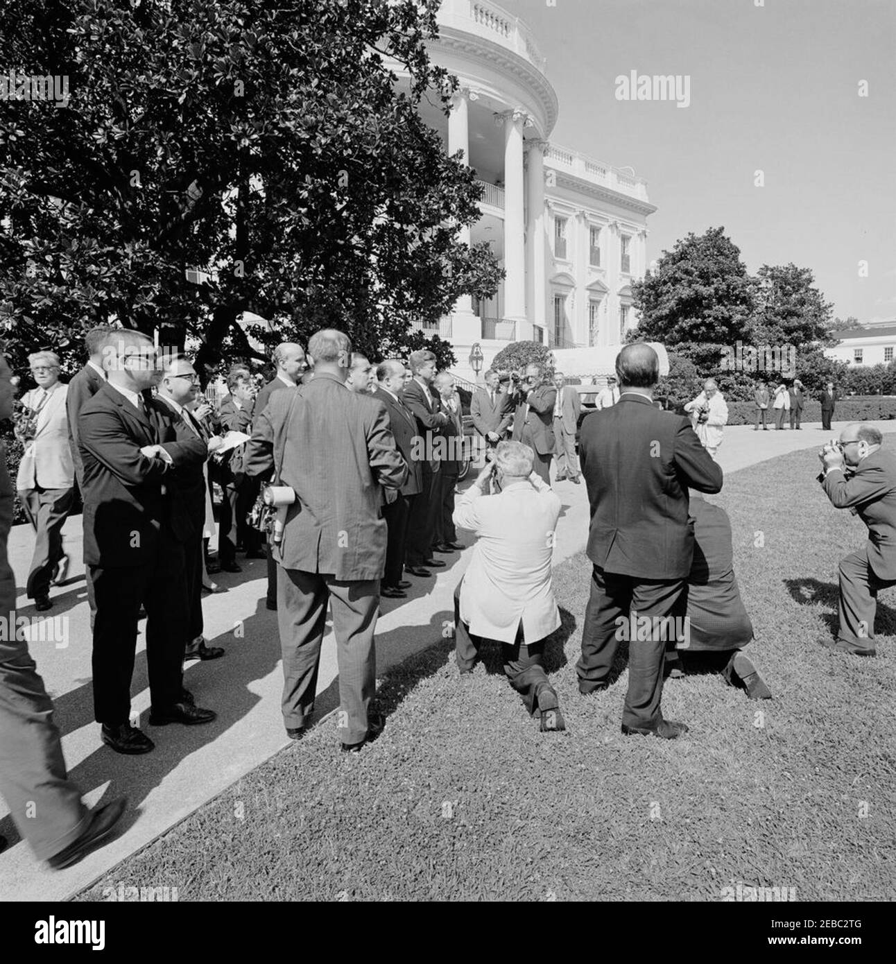 Ceremony marking Vice President Lyndon B. Johnsonu0027s (LBJ) departure on a good-will trip, 3:30PM. President John F. Kennedy (center) and others bid farewell to Vice President Lyndon B. Johnson as his helicopter departs the South Lawn for a good-will trip to Lebanon, Iran, Turkey, Greece, Cyprus, and Italy. Also pictured: Ambassador of Lebanon, Ibrahim Hussein el-Ahdab (al-Ahdab); Ambassador of Nicaragua and Dean of the Diplomatic Corps, Dr. Guillermo Sevilla-Sacasa; Ambassador of Italy, Sergio Fenoaltea; National Park Service (NPS) photographer, Abbie Rowe; White House Secret Service agent Stock Photo