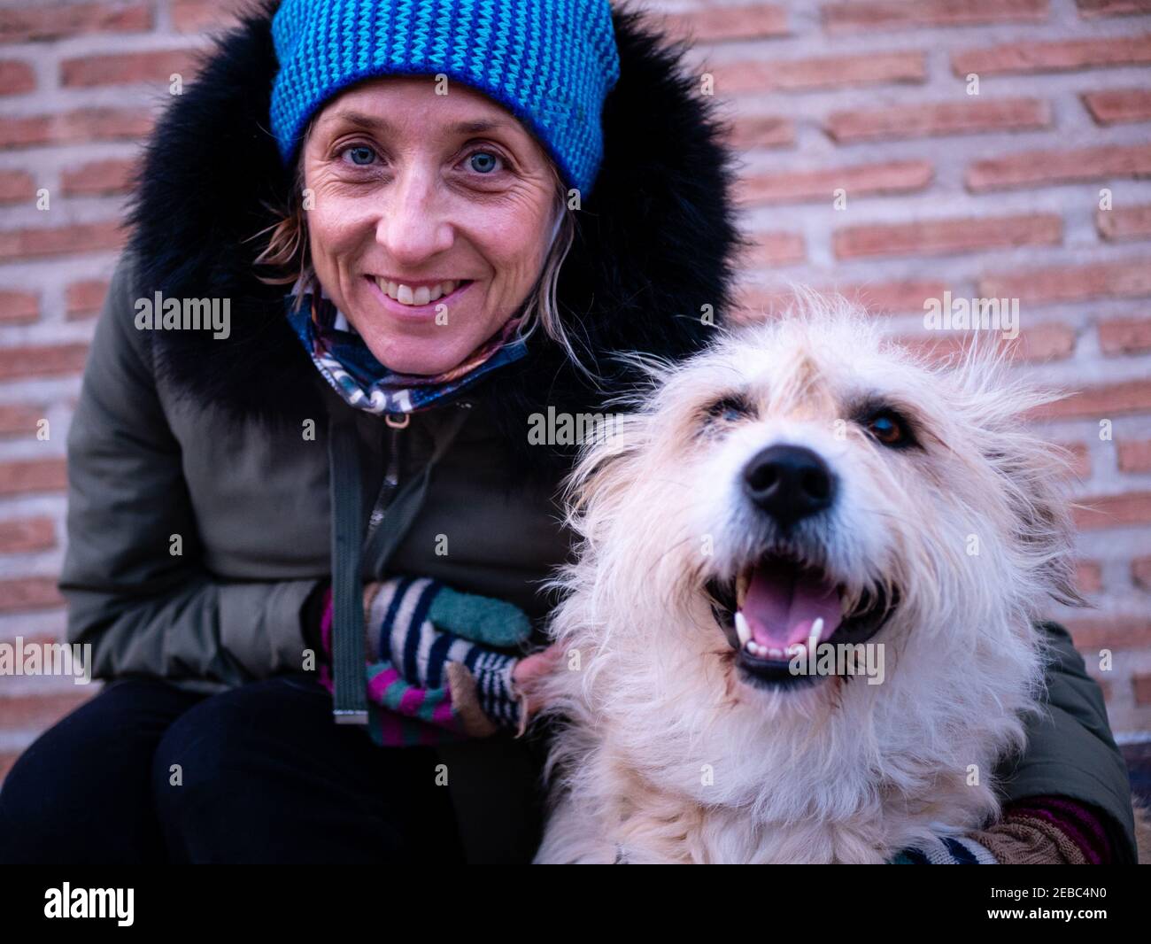Attractive blonde woman with blue eyes, in winter, posing with her