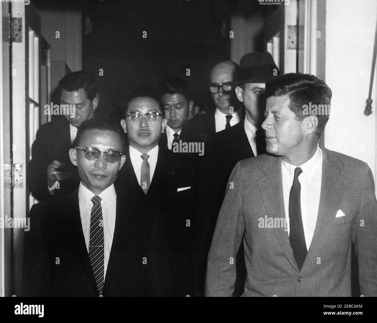 General Chung Hee Park, Chairman, Supreme Council of Korea, pays farewell call on the President, 4:00PM. President John F. Kennedy and General Chung Hee Park, Chairman of the Supreme Council for National Reconstruction of the Republic of Korea, leave the White House after General Parku0027s farewell visit with President Kennedy. Also included in the photograph are Il Kwon Chung, Korean Ambassador to the United States (center, wearing glasses); and Special Assistant to the President Dave Powers (in back, wearing glasses). West Wing Entrance, White House, Washington, D.C. Stock Photo