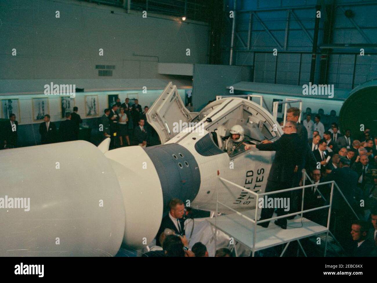 Inspection tour of NASA installations: St. Louis, Missouri, McDonnell Aircraft, 3:27PM. President John F. Kennedy views a mock-up of the Gemini space capsule, during a tour of the McDonnell Aircraft Corporation plant in St. Louis, Missouri. On platform, in foreground (L-R): McDonnell engineer, Elbert Wiegand (seated in cockpit of the two-man spacecraft); Vice President of the McDonnell Aircraft Corporation and General Manager of Projects Mercury and Gemini, Walter F. Burke (gesturing with hand); President Kennedy. Also pictured: Chairman of the Board and Chief Executive Officer of the McDonnel Stock Photo