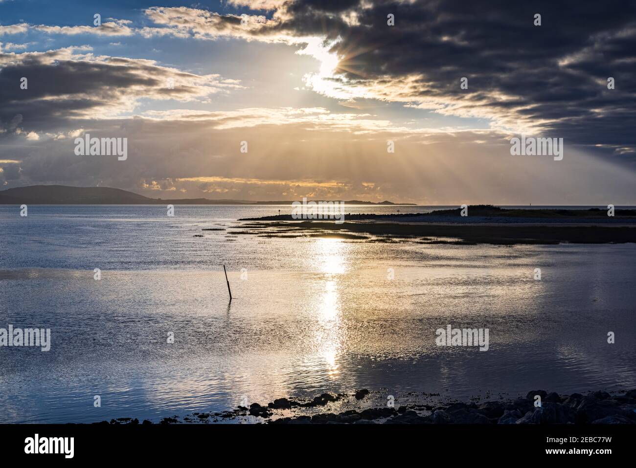 Early Evening with setting suns and Crepuscular rays Stock Photo