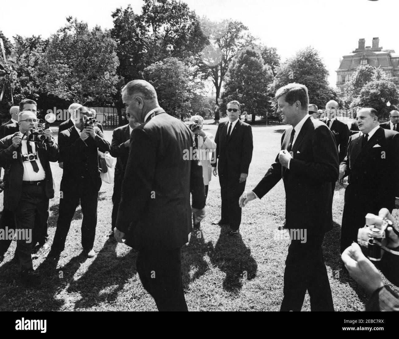 Ceremony marking Vice President Lyndon B. Johnsonu0027s (LBJ) departure on a good-will trip, 3:30PM. President John F. Kennedy walks with Vice President Lyndon B. Johnson to a helicopter on the South Lawn, prior to Vice President Johnsonu2019s departure for a good-will trip to Lebanon, Iran, Turkey, Greece, Cyprus, and Italy. Also pictured: Ambassador of Nicaragua and Dean of the Diplomatic Corps, Dr. Guillermo Sevilla-Sacasa; Chief of Protocol, Angier Biddle Duke; Deputy Assistant Secretary of State, Carl T. Rowan; motion picture photographer for Columbia Broadcasting System (CBS), Tom J. C Stock Photo