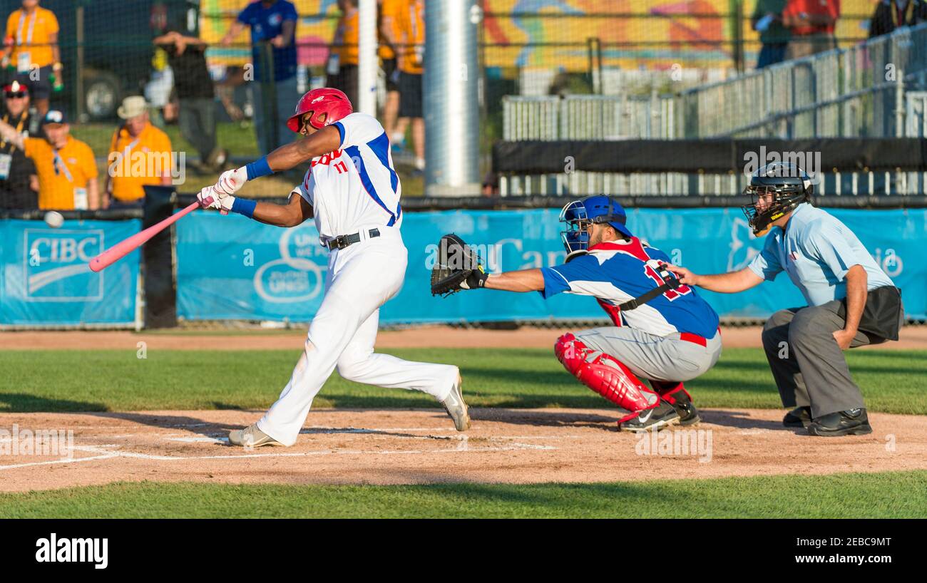 Toronto Panam Baseball 2015-Cuba vs the Dominican Republic:  Yosvany Alarcon (Cuba 11) wins the duel with the pitcher Adalberto Mendez by hitting a double Stock Photo