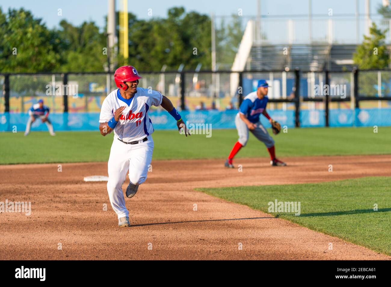 Toronto Panam Baseball 2015-Cuba vs the Dominican Republic: Yosvany Alarcon steals third base in front of pitcher Adalberto Mendez. He will later score put Stock Photo