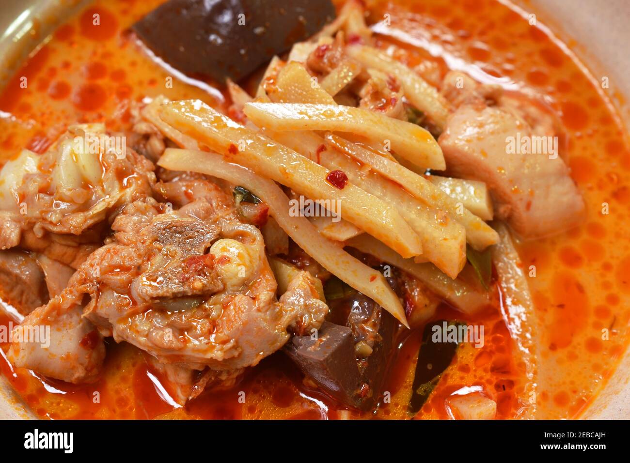 spicy boiled slice fresh bamboo shoot with chicken and blood in coconut milk curry soup on bowl Stock Photo
