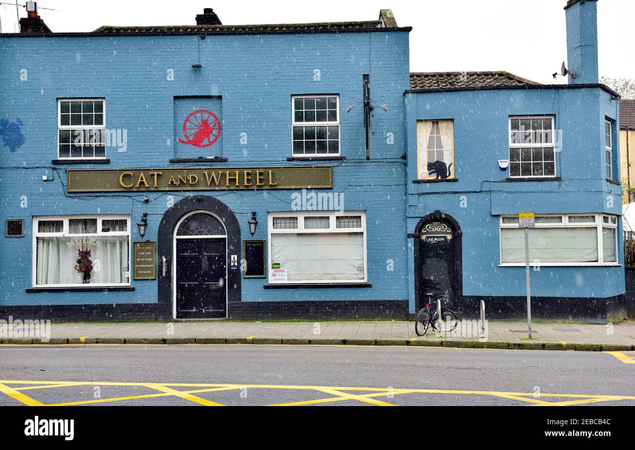 Pub (Cat and Wheel) closed to customers during covid-19 pandemic lock down with light snow falling, UK Stock Photo