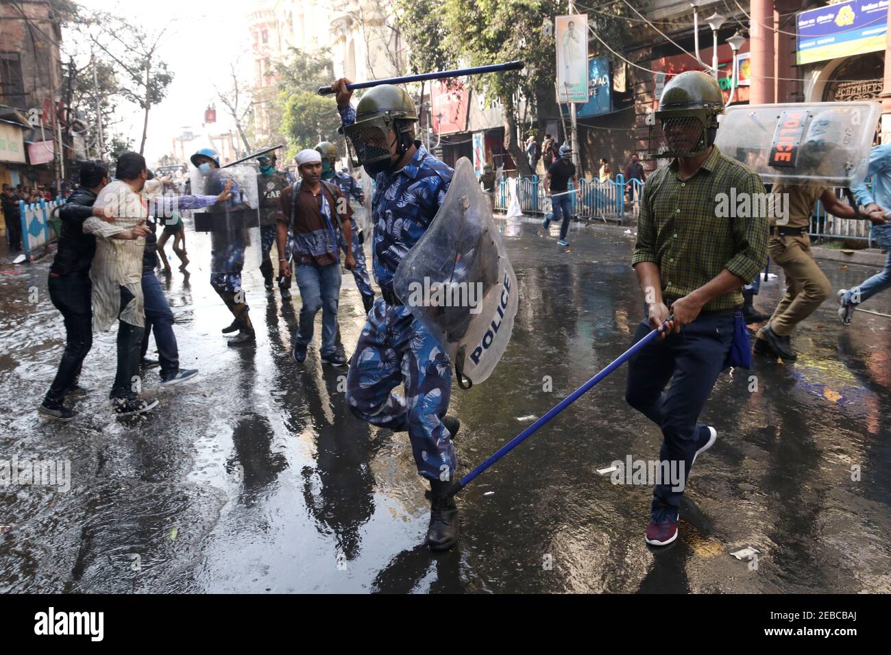 Members of Left and Youth Congress party and youth organization activists  try to cross security barricade as police use water canon and baton charge  during a protest against different policies of the
