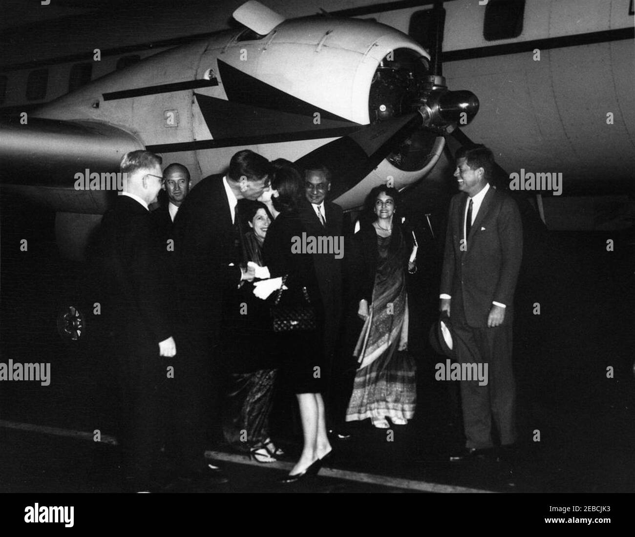 President Kennedy greets First Lady Jacqueline Kennedy (JBK) at Andrews Air Force Base upon her return from her trip to India and Pakistan, 7:25PM. United States Ambassador to India John Kenneth Galbraith kisses First Lady Jacqueline Kennedy as she returns from her trip to India and Pakistan. (L-R) Assistant Secretary of State for Near Eastern and South Asian Affairs Phillips Talbot; United State Chief of Protocol Angier Biddle Duke; Ambassador Galbraith; Shobha u201cForiu201d Nehru (wife of Braj Kumar Nehru, Ambassador to the United States from India); the First Lady; Ambassador Nehru; Sher Stock Photo