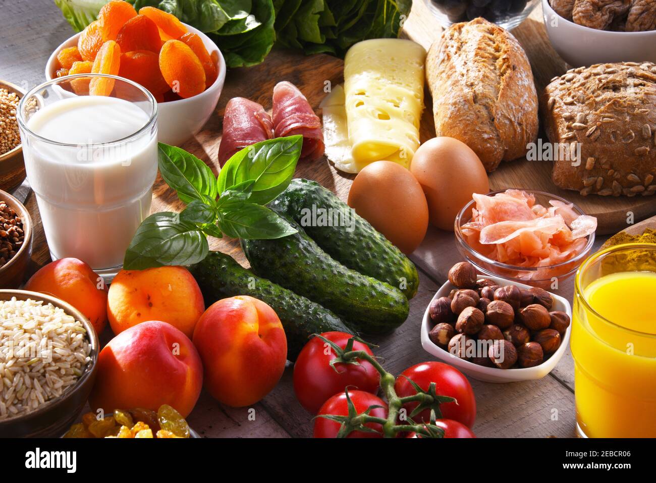 Composition with assorted organic food products on wooden kitchen table ...
