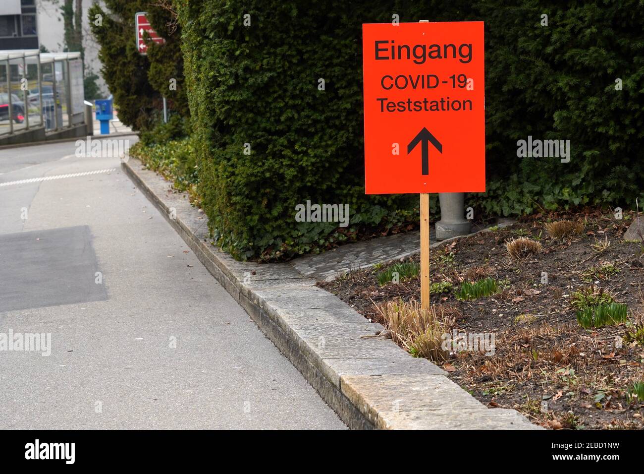 Test station Covid19 signpost in German in orange color showing with